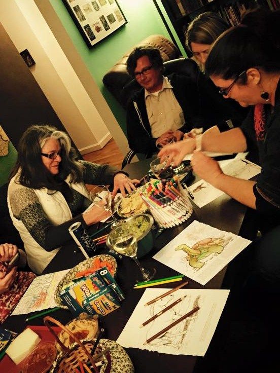 A group of adult friends at a coloring book party