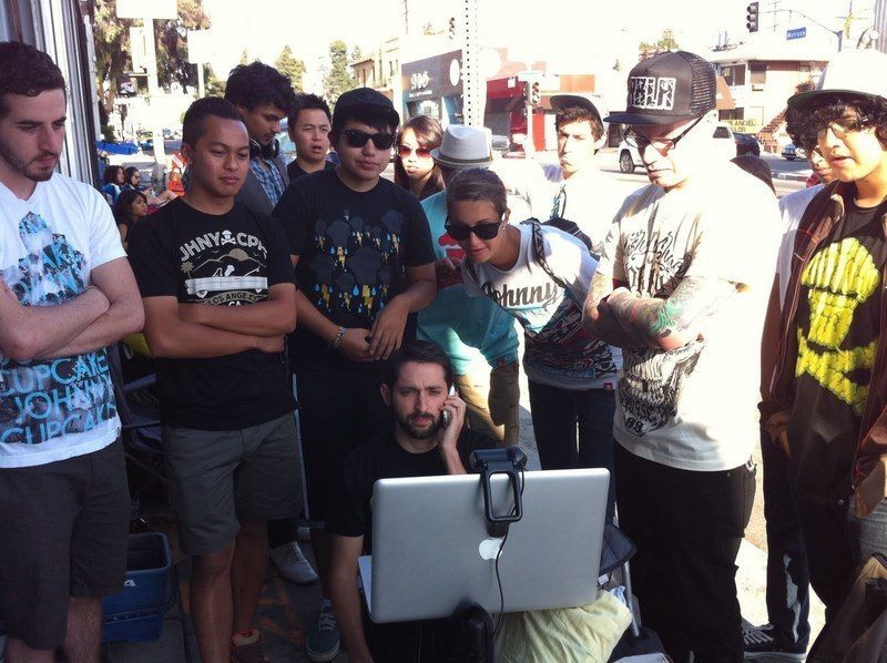 Johnny Earle with customers in front of Johnny Cupcakes Los Angeles shop